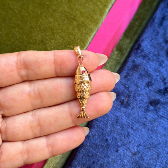 Moving fish pendant with a red stone eyes