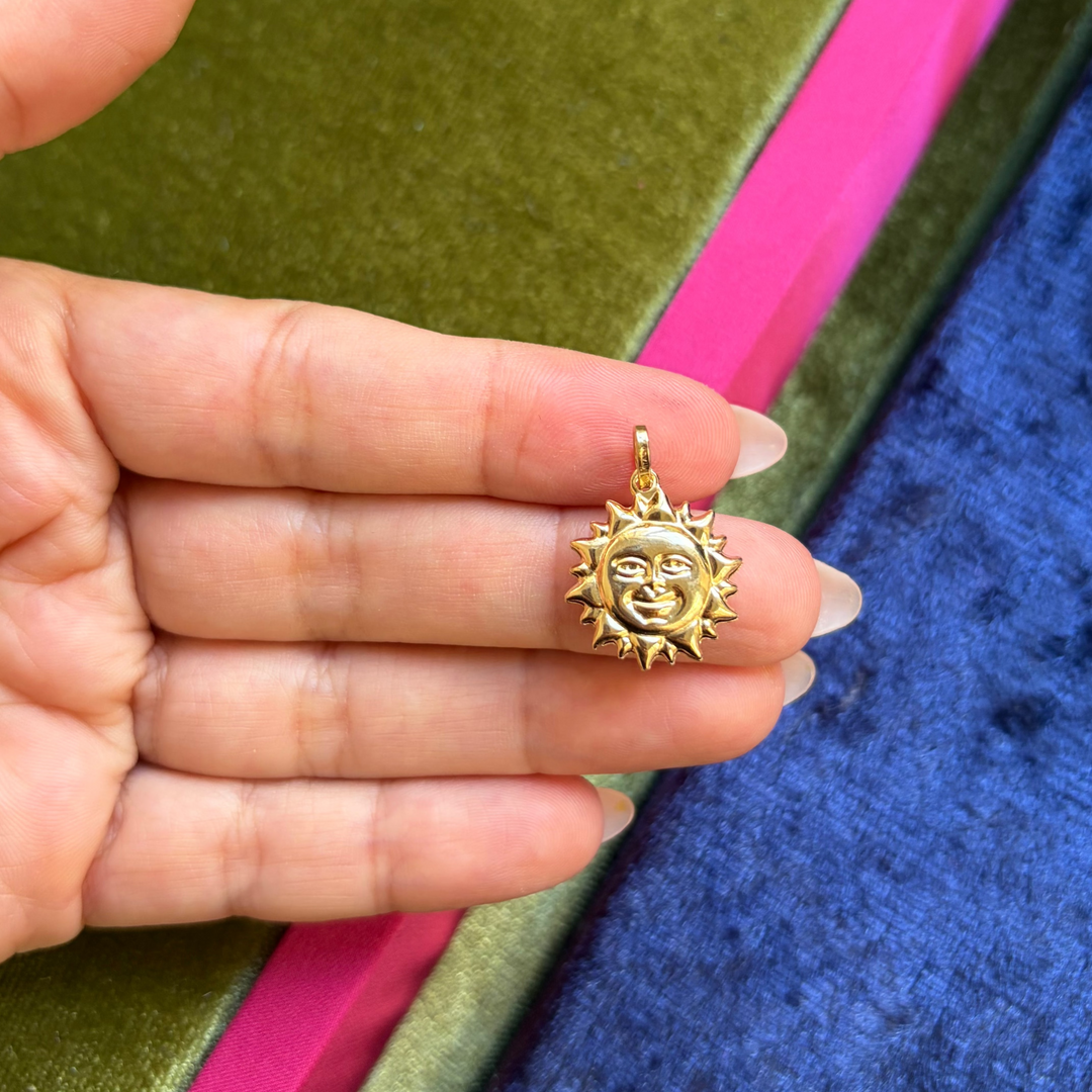 Large sun with face charm