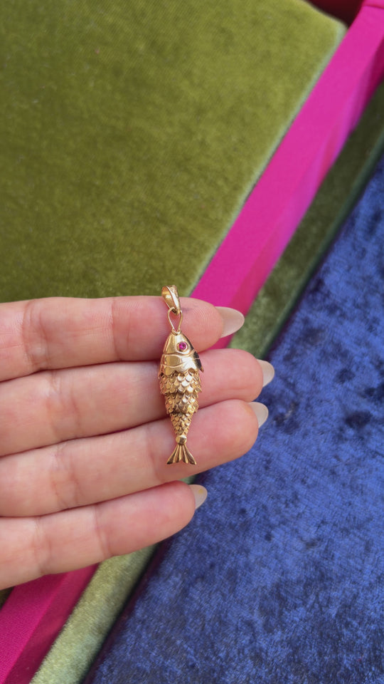 Moving fish pendant with a red stone eyes